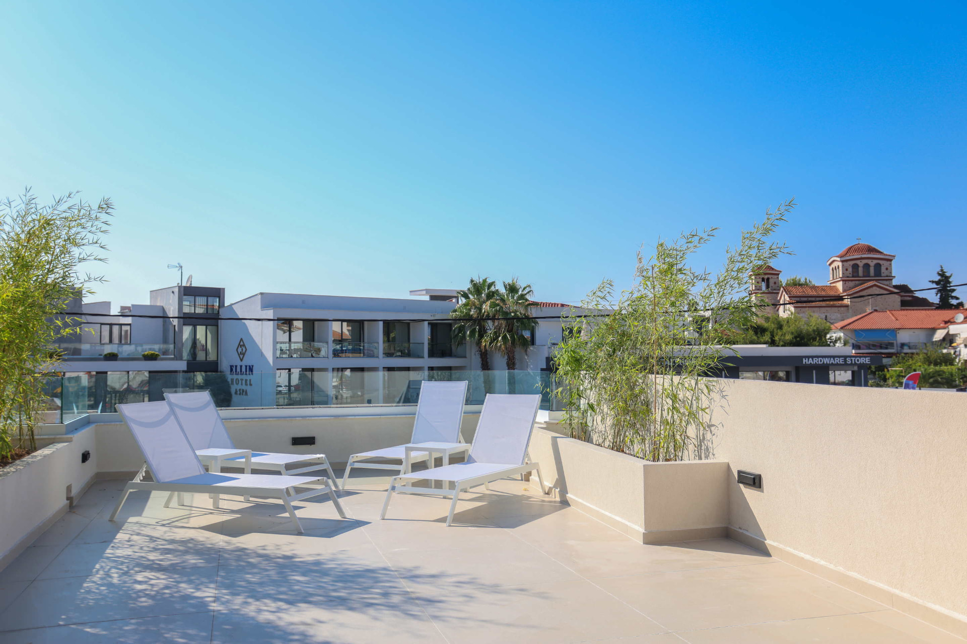 Sun terrace with loungers overlooking central Kallithea rooftops